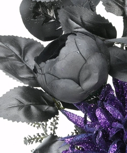 Detail of black silk roses and purple glitter accents on a Halloween floral wreath decoration