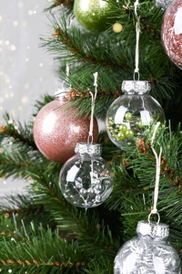 Macro detail of Christmas tree balls with snowflake relief caps and festive fillers
