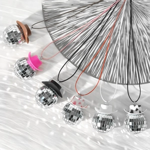 Disco ball cowboy hat ornaments with mirror glass reflections on white fabric