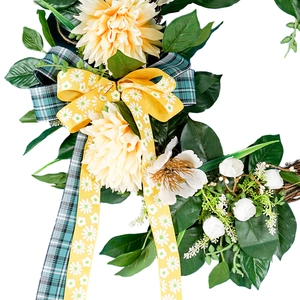 Artificial floral wreath with yellow dahlias, plaid ribbons and green leaves for door decor