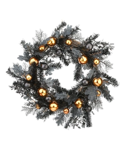 Detail of Halloween wreath featuring black pine needles, golden ornaments, and dark foliage