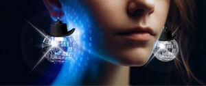 Close-up of silver disco ball earrings with black cowboy hats worn by a model