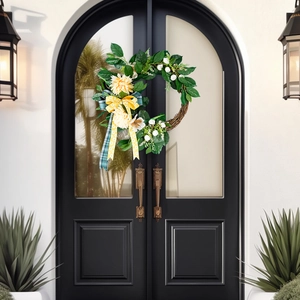 Handmade Christmas door wreath with yellow dahlia flowers, green leaves and ribbon bow