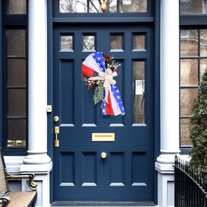 Patriotic 4th of July wreath with stars, stripes and burlap bow on blue door
