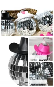 Detail of disco ball mirror with mini cowboy hat and pink hanging rope decor