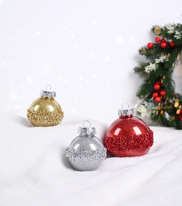 Nahaufnahme glitzernder Weihnachtskugeln in Gold, Silber und Rot mit Perlentextur-Details