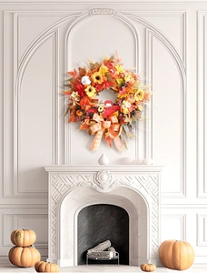 Close-up of harvest wreath with vintage red truck, pumpkins, and a plaid bow