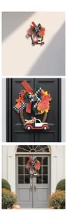 Detail of harvest wreath with maple leaves, plaid bows, and wooden truck on doors