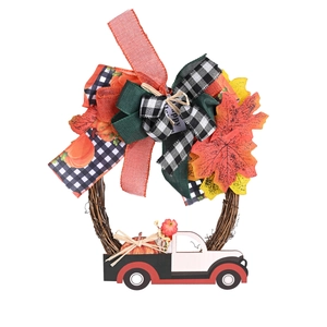 Fall harvest wreath with orange ribbons, maple leaves and mini pumpkin truck on rattan base