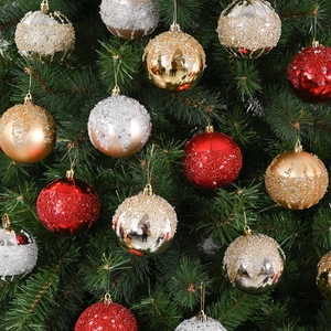 Red, gold and silver Christmas ball ornaments with glitter and beads on tree