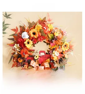 Detail of harvest wreath featuring a red pickup truck, sunflowers, and mini pumpkins