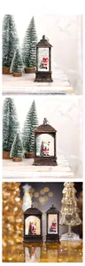Detail of vintage bronze Christmas lantern with Santa scene and swirling glitter light
