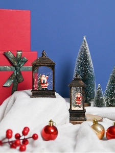 Detailed view of vintage bronze water lanterns with Santa Claus and glitter snow
