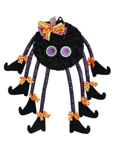 Detail of Halloween spider decor with purple striped legs and orange polka dot bows