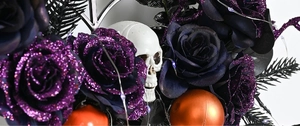 Detail of Halloween wreath with purple glitter rose, white skull, and purple LED lights