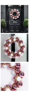 Pink and white Christmas ball wreath displayed on a black door and close-up detail view