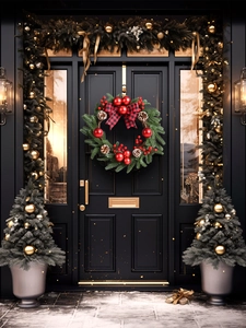 Close-up of 45cm Christmas wreath with red berries and bow hanging on a black door