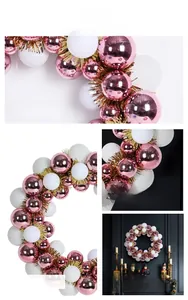 Detail of pink and white Christmas wreath with electroplated balls and gold tinsel accents