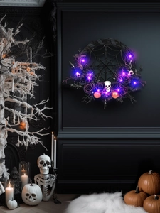 Detail of Halloween wreath with black roses, purple LED lights, spiders and tiny skulls