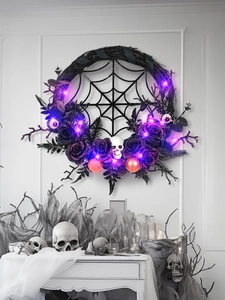 Detail of Halloween wreath with purple LED lights, black roses and skull ornaments