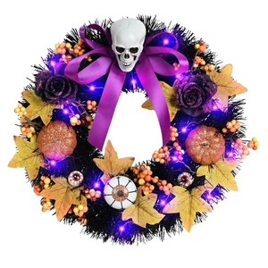 Detail of Halloween wreath with glowing LED lights, skulls, pumpkins and purple roses