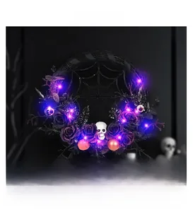 Detail of lit Halloween wreath with purple LEDs, black roses, and a white skull