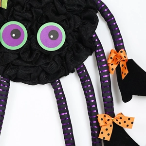 Black mesh spider decoration with purple stripes and orange bows for Halloween party decor