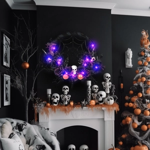 Halloween wreath with black spider webs, roses, skulls and purple LED lights on a wall