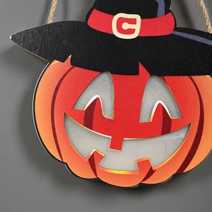 Detail of wooden Halloween pumpkin ornament with witch hat and natural jute rope