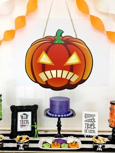 Detail of Halloween pumpkin door sign hanging with glowing eyes for festive party decor