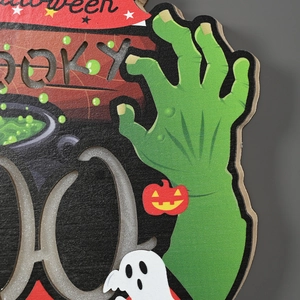 Detail of wooden Halloween door sign featuring a zombie hand, pumpkin, and spooky text