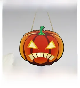 Detail of wooden Halloween pumpkin sign with demon face design and rustic hanging rope
