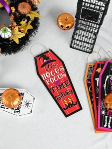 Detailed view of coffin-shaped wooden Halloween door hangers on grey textured background