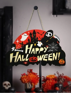 Detail of wooden Happy Halloween door sign with spooky ghosts and pumpkin hanging on wall