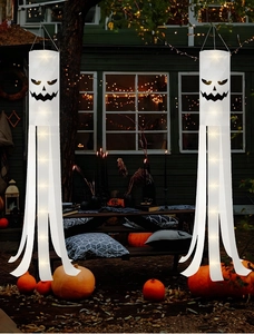 Outdoor Halloween ghost windsocks with LED lights hanging near a porch at night