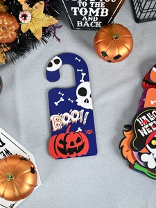 Detail of Halloween door hanger with orange pumpkin, white skull, and BOO text