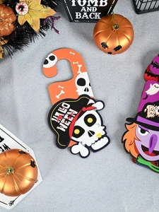 Detail of pirate skull and witch Halloween door signs on a silver glitter background