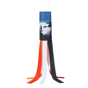 Macro detail of Halloween windsock featuring a flying witch silhouette and colorful ribbons