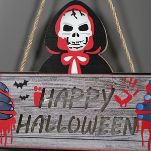 Detail of wooden Happy Halloween door sign with skull and blood handprints