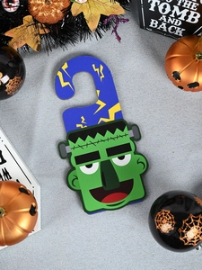 Detail of Frankenstein monster door hanger with lighting bolt and comic style finish