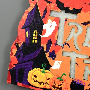 Detail of wooden Halloween Trick or Treat sign with hollowed letters and pumpkin print