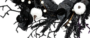 Macro shot of Halloween wreath with white pumpkins, black leaves and gothic twigs