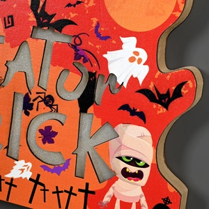 Detailed laser-cut Trick or Treat wooden sign featuring cute mummy and ghost illustrations