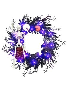 Detail of Halloween wreath with black pine needles, LED lights and pumpkin accents
