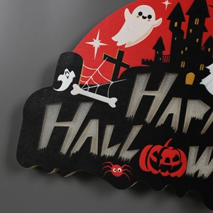 Macro shot of tiered Happy Halloween sign with silver glitter text and spooky motifs