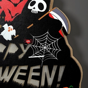 Macro view of Happy Halloween cut-out sign with silver glitter and gothic ghost elements