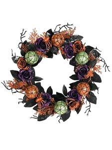 Close-up of Halloween wreath featuring glittery purple roses and orange spiders on black vines