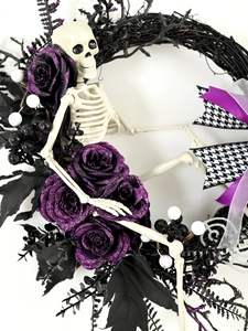 Dettaglio della ghirlanda di Halloween con rose glitter viola e piccolo scheletro