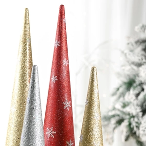 Close-up of glittered cone Christmas tree ornaments with white snowflake patterns