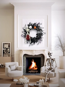 Halloween wreath with purple twigs, pumpkins, and skeleton over a cozy fireplace